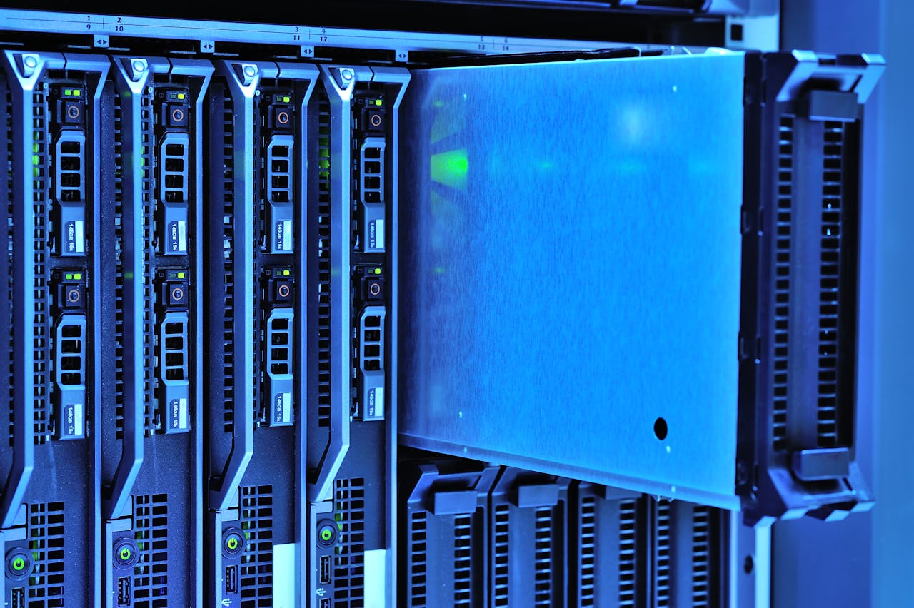 services-03 Detailed view of server racks with glowing lights in a data center environment.