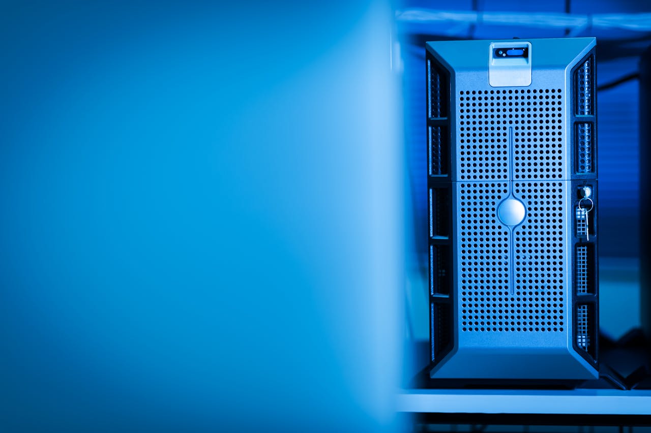about-01 Close-up of a modern server unit in a blue-lit data center environment.